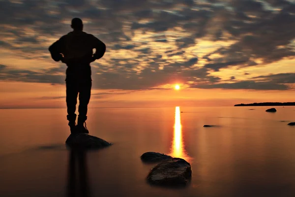 Close-up of a person's hands in a meditative pose.